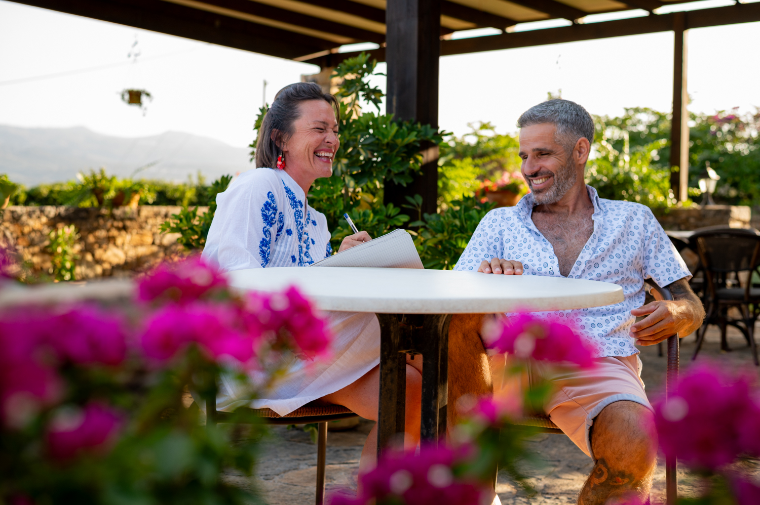 Two people laughing over coffee, Crete