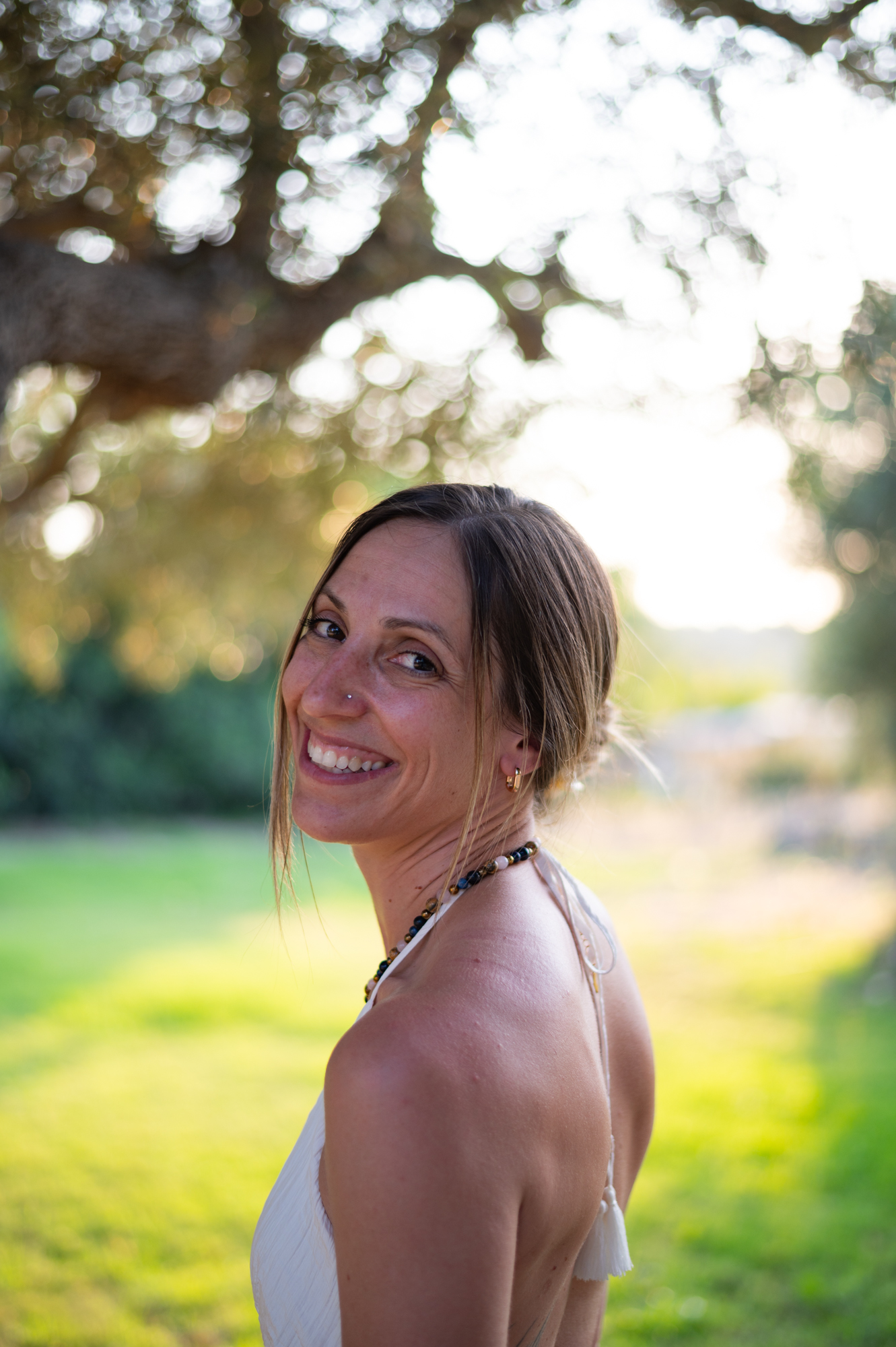 Backlit portrait under an olive tree at golden hour, Crete